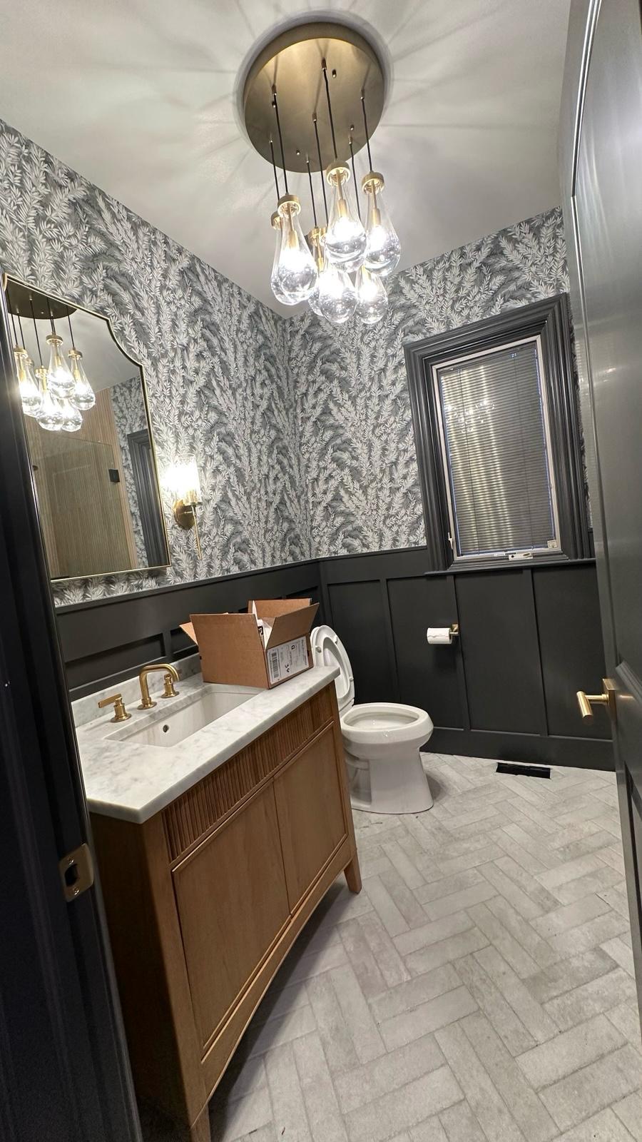 Painted powder room with wallpaper accent
